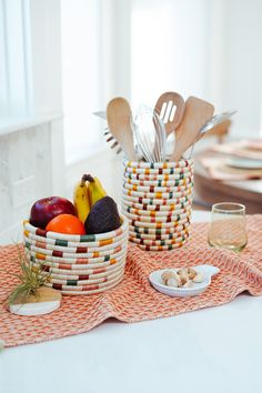 a table topped with plates and bowls filled with food next to utensils on top of a table