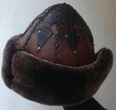 "Completely hand stitched Handmade This Leather hat is extremely thick and very warm.Made Genuine leather and Sheep Fur. Please be sure to measure the size of your head before buying. Measuring; Measuring for your head size is, You can use a tape measure (or a length of string that you will have to hold up to a tape measure) to determine the length. Place the string or tape around your head about 1/8\" above your ear, across the mid-forehead, completely circling your head. Hold the tape firmly, Traditional Handmade Costume Hats And Headpieces, Handmade Artisan Hat Bands For Winter, Unique Handmade High Crown Hat, Traditional Handmade Brown Hat Bands, Handmade Curved Brim Costume Hat, Unique Handmade Brimmed Costume Hats And Headpieces, Handmade Costume Hat With Curved Brim, Unique Handmade Brimmed Costume Hat, Handmade Brown Brimmed Costume Hats And Headpieces