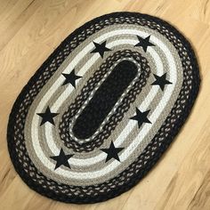 a black and white area rug with stars on the floor in front of a wooden floor