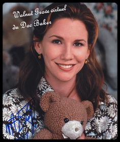 a woman holding a teddy bear in her hands