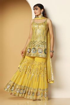 Yellow sleeveless padded short kurta in georgette base with metallic sequin vines, chevron and floral swirl embroideries. Paired with a sequin garden embellished tiered sharara and ditsy sequin motif embellished net dupatta. - Aza Fashions Sleeveless Georgette Sharara With Gota Work, Fitted Sleeveless Sharara For Eid, Sleeveless Sharara With Gota Work For Festivals, Designer Wear Sleeveless Sharara For Navratri, Semi-stitched Sleeveless Sharara For Festivals, Festival Sleeveless Sharara With Gota Work, Fitted Sleeveless Sharara With Dupatta, Sleeveless Sharara With Mirror Work For Navratri, Festive Sleeveless Sharara With Dabka Work