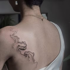 a woman with a tattoo on her back