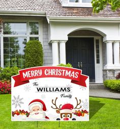 a merry christmas yard sign in front of a house with santa claus and reindeer decorations