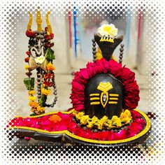 an elaborately decorated display with flowers and decorations on it's sides, in front of a white background