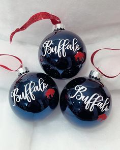 three black christmas ornaments with buffalo on them