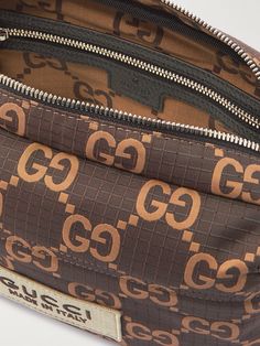 The 'double G' monogram, from the initials of founder Guccio Gucci, has been used by the house for almost a century. Made from ripstop, this messenger bag is jacquard-woven with the emblem and appliquéd with an additional logo patch for good measure. The main compartment is spacious enough for your essentials, and there's an external zipped pocket for smaller items. Brown Travel Bag With Embroidered Logo, Brown Rectangular Bag With Embroidered Logo, Designer Brown Bags With Embroidered Logo, Gucci Rectangular Bag With Embroidered Logo, Designer Gucci Bag With Embroidered Logo, Gucci Designer Bag With Embroidered Logo, Designer Shoulder Bag With Embroidered Logo For Travel, Brown Monogram Canvas Shoulder Bag With Monogram Print, Brown Monogram Canvas Shoulder Bag