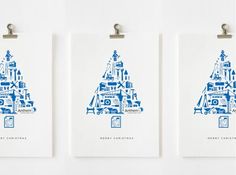 three blue and white christmas cards hanging from hooks