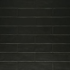 a black brick wall with white trim