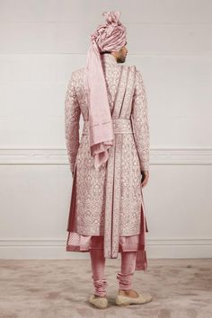 Salmon sherwani with all-over floral motif aari, zardozi work paired with kurta and churidar. Comes with safa, stole, kamarbandh and jutti fabric.
Components:7
Embroidered
Neckline:Mandarin Collar
Sleeve Length:Sherwani: Full
Fabric:Raw Silk, Jacquard, Cotton Silk and Chanderi
Color:Pink
Side slits
Closure: Sherwani: Concealed front placket
Note: Brooch on the safa is not for sale - Aza Fashions Eid Traditional Sherwani With Chikankari Embroidery, Traditional Fit Bandhgala For Eid, Eid Traditional Bandhgala, Traditional Fit Sherwani With Zari Work For Eid, Traditional Fit Sherwani With Intricate Embroidery For Diwali, Embroidered Bollywood Sherwani With Traditional Fit, Traditional Fit Embroidered Bollywood Sherwani, Eid Sherwani With Zari Work In Traditional Fit, Eid Sherwani With Zari Work And Traditional Fit