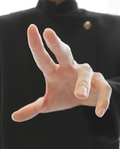 a person making a hand gesture with their fingers