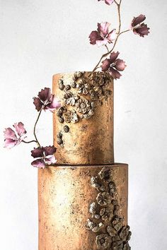 a three tiered cake with flowers on top