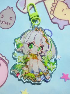 a keychain with an anime character on it and other items around it in the background