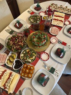 a table topped with lots of different types of foods and desserts on top of plates