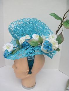 "* This design sits off to the side of the head allowing it to be worn on either the right or left side. One side features more of the white flowers and the other side has more of the folding. * The hat form is 14\" in diameter with a light weight weave and designed with white silk Wild Roses. Tiny turquoise daisy like flowers pick up the color in the hat forms. * It is light weight, balanced and comfortable to wear and upon ordering you will receive this exact fascinator. * Designed on a wide a Turquoise Headpiece For Summer Wedding, Turquoise Headpieces For Summer Weddings, Turquoise Summer Wedding Headpiece, Summer Wedding Turquoise Headpieces, Spring Turquoise Headpiece For Parties, Spring Turquoise Fitted Fascinator, Turquoise Fascinator For Spring Wedding, Turquoise Headpieces For Spring Weddings, Spring Wedding Turquoise Headpieces