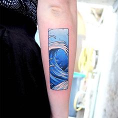 a woman with a tattoo on her arm has a blue wave in the ocean behind it