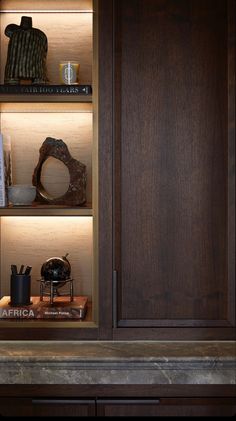 a wooden cabinet with books and other items in it