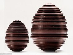 two brown vases sitting next to each other on a white surface