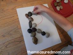 a child is making rocks on the paper