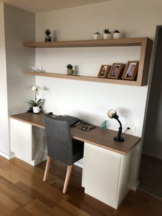 a desk with two shelves above it and a chair next to it on a hard wood floor