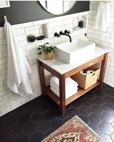 the bathroom is decorated in black and white with touches of yellow to give it an eclectic feel