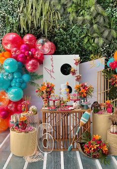 an outdoor party with balloons and decorations