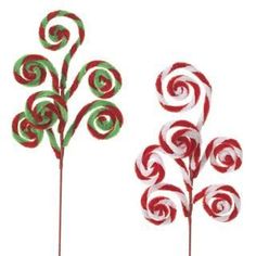 three candy canes are in the shape of christmas trees, one red and one green