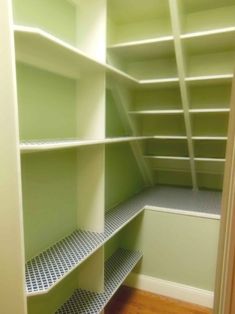 an empty walk in closet with lots of shelves