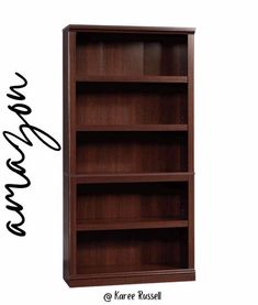 a wooden bookcase with writing on the bottom and bottom shelf below it, in front of a white background