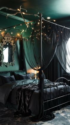 a bedroom with green walls and lights on the ceiling, along with a four poster bed