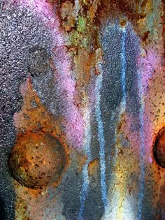 an old rusted metal surface with circles and spots