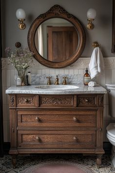 a bathroom with a sink, mirror and toilet in it's centerpieces