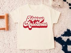 Merry Christmas Toddler Shirt, Kids Christmas Shirt, Toddler Christmas Shirt, Cute Kids Christmas Shirts, Holiday Tees, Natural Toddler Tee 💗  Welcome to The WildflowerbyMiley Etsy Shop!  This listing is for the bodysuit, sweatshirt or t-shirt only. All other items that are shown in our photos such as shoes, hats, beanies, blankets etc. are for photo staging purposes and are NOT INCLUDED in the sale. DESCRIPTION:  This baby and children's unisex essential fits like a well-loved favorite. Super soft t-shirts, sweatshirts and baby bodysuits for your little lads and gals meant to showcase their big personalities. Its Excellent quality and vibrant print makes one fall in love with it over and over again.  This adorable piece is the perfect lightweight layer for casual wearing.  This product i Kids Christmas Shirts, Holiday Tees, Kids Christmas Shirt, Toddler Christmas Shirt, Christmas Toddler, Christmas Shirts For Kids, Toddler Christmas, Toddler Tees, Christmas Shirt