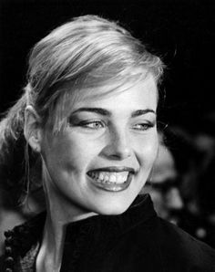 an old black and white photo of a woman with blonde hair smiling at the camera