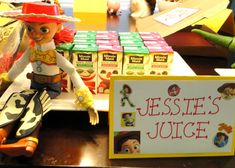 there is a sign that says jellie's juice next to some toy figurines