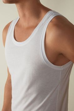 Crew neck tank top in 100% Extra-Fine SUPIMA® Cotton. Incredibly soft and breathable, this premium fiber offers excellent elasticity. The structure of the fabric means it will last wash after wash. A simple, comfortable style that's ideal for any occasion, whether worn as an undershirt or as an everyday shirt. Stretch Sleeveless Tops With Soft Touch, Stretch Scoop Neck Top For Daywear, Stretch Soft Touch Tops For Everyday, Scoop Neck Stretch Top For Daywear, Everyday Stretch Tops With Soft Touch, Soft Touch Stretch Tops For Everyday, Casual Summer Tops With Soft Touch, Classic Scoop Neck Tops For Layering, Everyday Seamless Summer Top