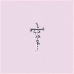 a cross with flowers in the middle on a pink background