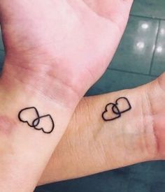 two people with matching tattoos on their wrists