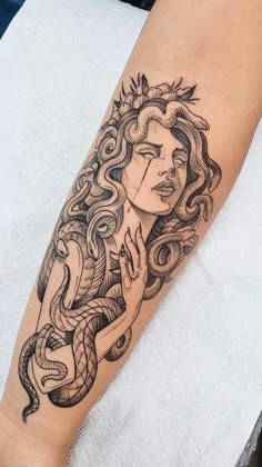 a woman's arm with an intricate tattoo design on the left side of her body