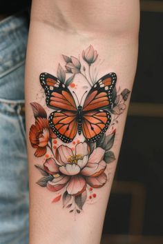 a woman's arm with a butterfly and flowers on it