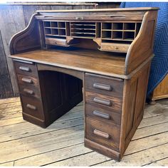 an old wooden desk with drawers on it