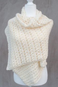 a white knitted shawl on top of a mannequin headdress