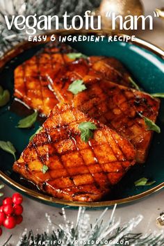 two pieces of grilled meat on a green plate with christmas decorations around it and the title vegan tofu ham easy and ingredient recipe