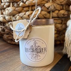 a white candle sitting on top of a wooden table