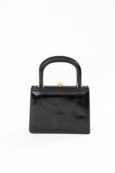 Small vintage handbag made of genuine black leather. Clasp lock, golden hardware.  Condition: Very good vintage condition, no major flaws. The handle fastenings are reliable. There are traces of patina on the metal parts and minor corner wear.  Interior: clean, no smell. A one compartment made of black leather, moderate wear.  Measures in cm: 21x17 Measures in inches: 8''x7'' Golden Furniture, Interior Clean, Vintage Handbag, Black Handbag, Purse Vintage, Top Handle Bags, How To Make Handbags, Vintage Handbags, Handle Bag