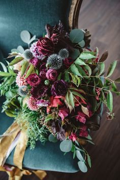 a bouquet of flowers sitting on top of a green chair