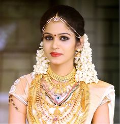 a woman wearing an elaborate necklace and earrings