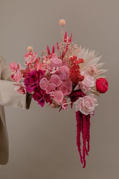 a person holding a bouquet of flowers in their hands