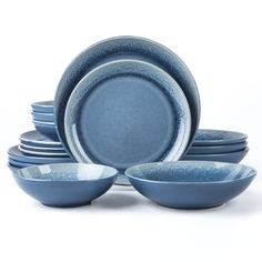 a stack of blue plates and bowls on a white background