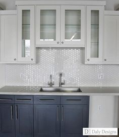 a kitchen with blue cabinets and white counter tops