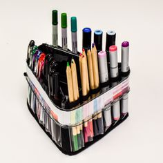 a black container filled with lots of pens and markers